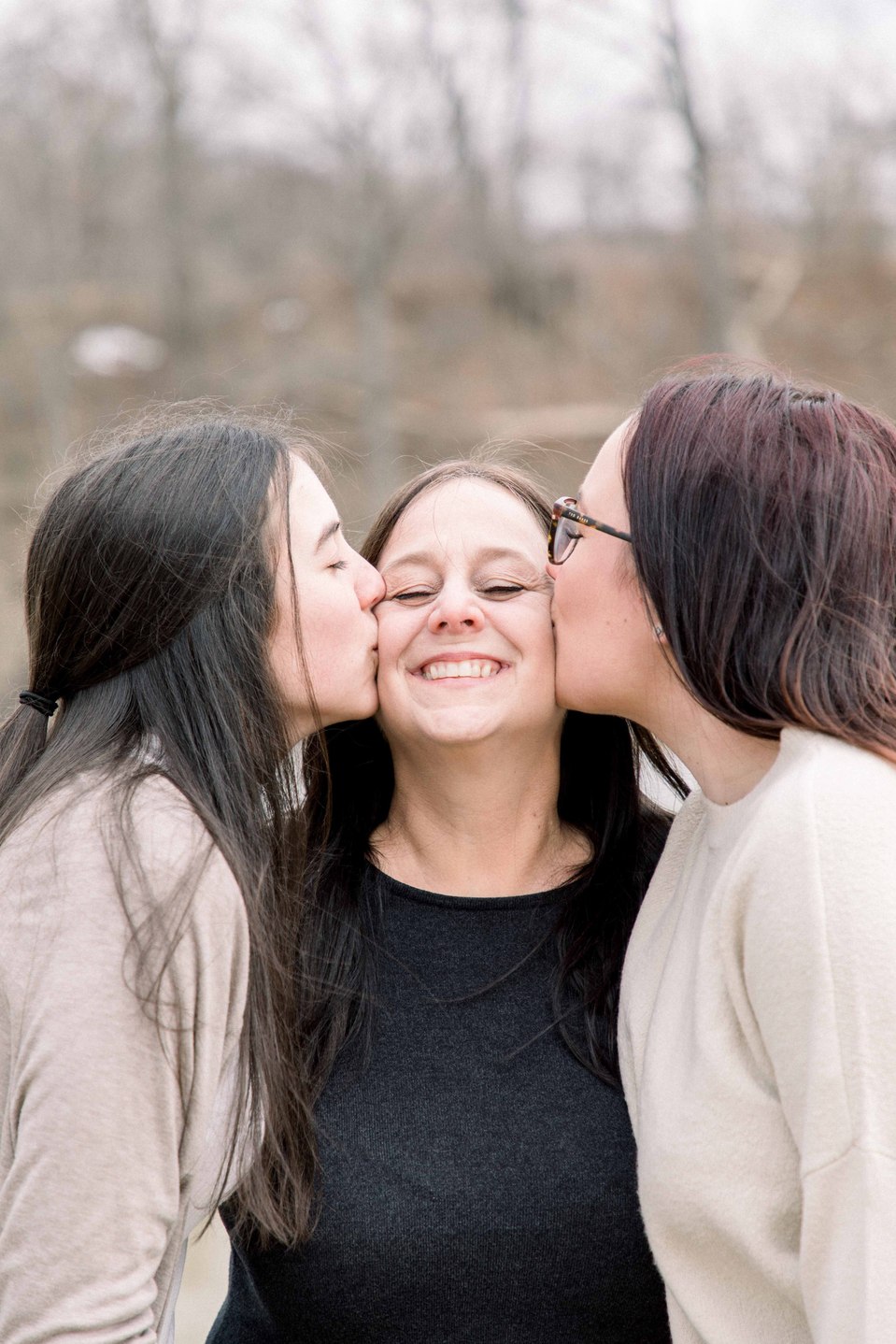 Portrait of two sisters kissing their mom on the cheek, Niagara family photographer, family photography, Niagara portrait photographer, portrait photography, Emily VanderBeek Photography.