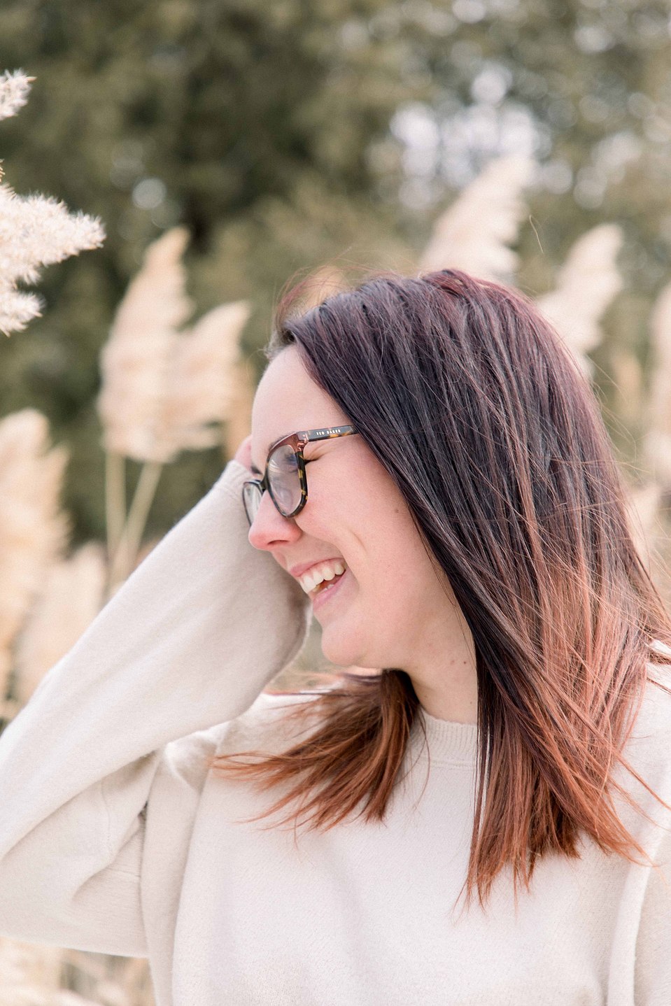 Candid portrait of girl smiling away from the camera while playing with her hair, Niagara family photographer, family photography, Niagara portrait photographer, portrait photography, Emily VanderBeek Photography.