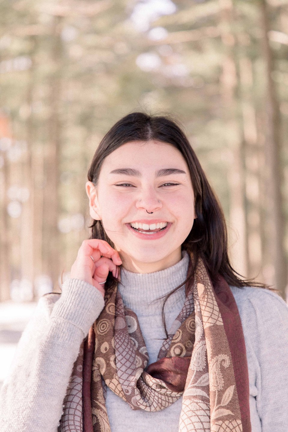 Candid portrait of young women playing with her hair on a winter trail, Niagara family photographer, family photography, Niagara portrait photographer, portrait photography, Champlain photographer, Hawkesbury photographer, Emily VanderBeek Photography.