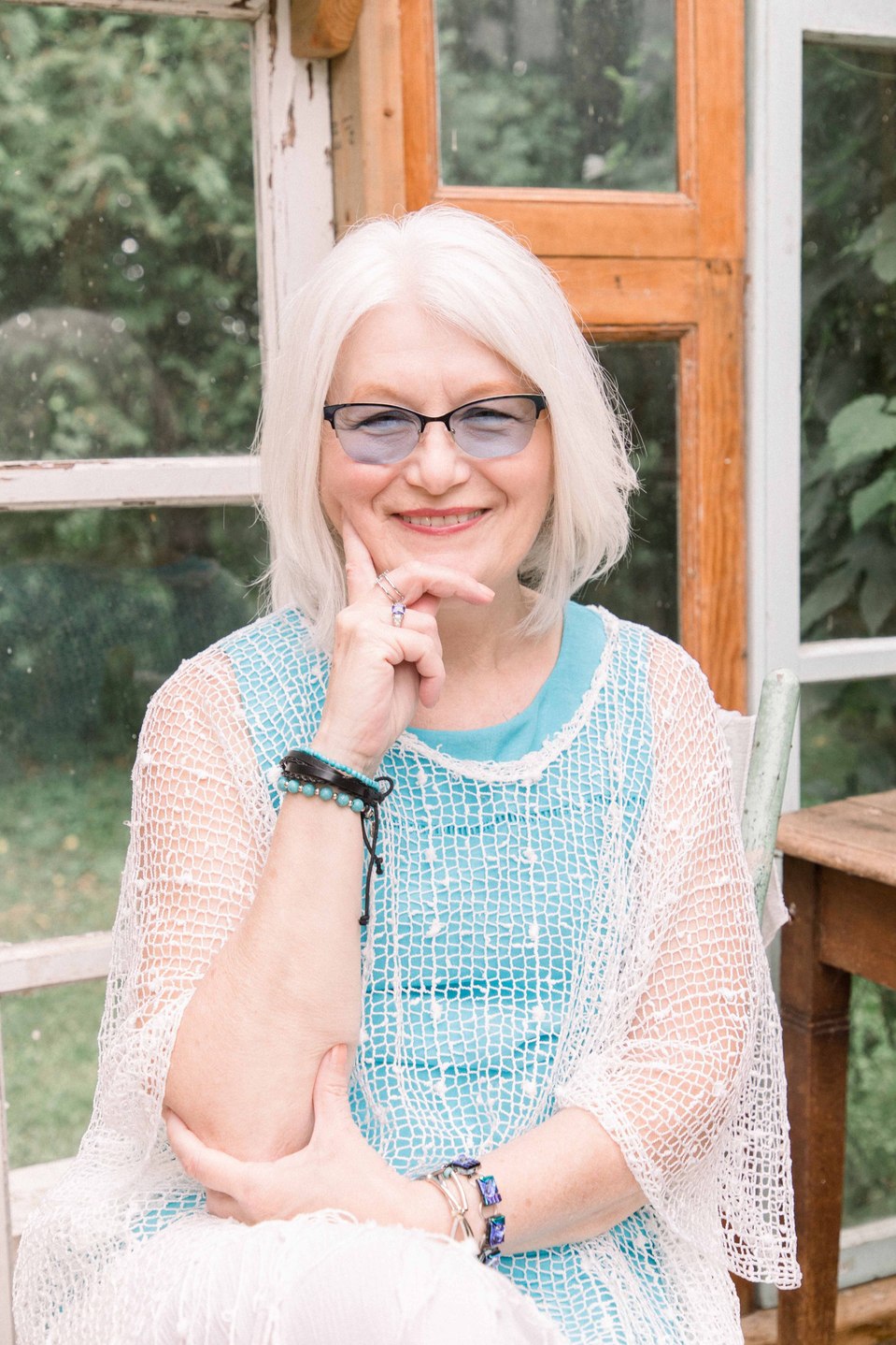 Portrait of older woman with glasses sitting in a greenhouse, Niagara family photographer, family photography, Niagara portrait photographer, portrait photography, Emily VanderBeek Photography.