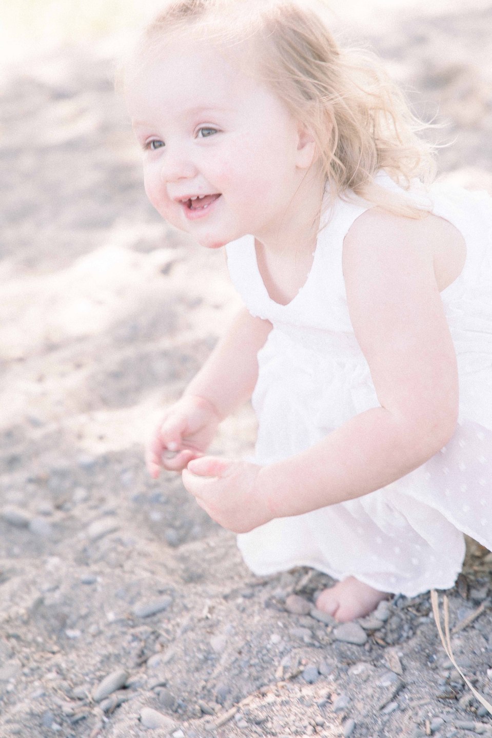 Portrait of little girl playing in the sand on the beach, Niagara portrait photographer, Niagara family photographer, portrait photography, family photography, candid photography, authentic photography, Emily VanderBeek Photography.