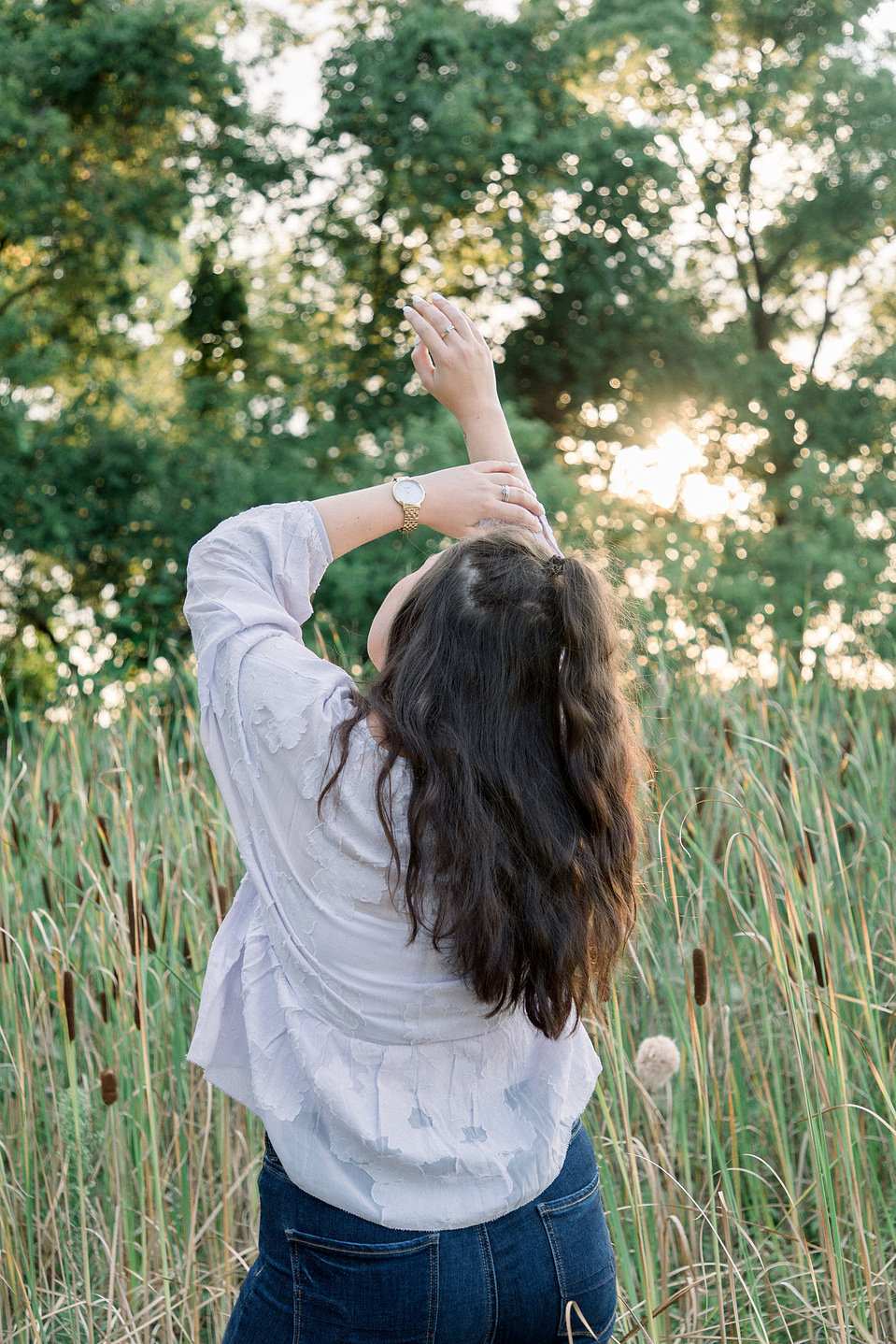 Full portrait of woman with her arms in the air, facing away from the camera. Niagara portrait photography, Niagara portrait photographer, Niagara branding photography, Niagara branding photographer.