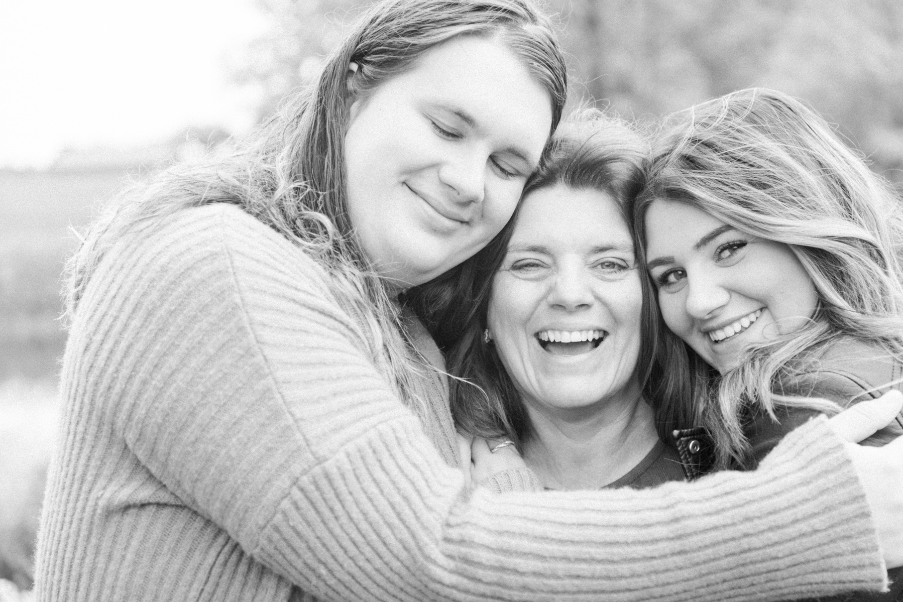 Black and white family photo of two sisters hugging mother, L'Orignal family photographer, Champlain family photographer, Hawkesbury family photographer, Quebec family photography, Vaudreuil-Soulanges Photographer, Emily VanderBeek Photography.