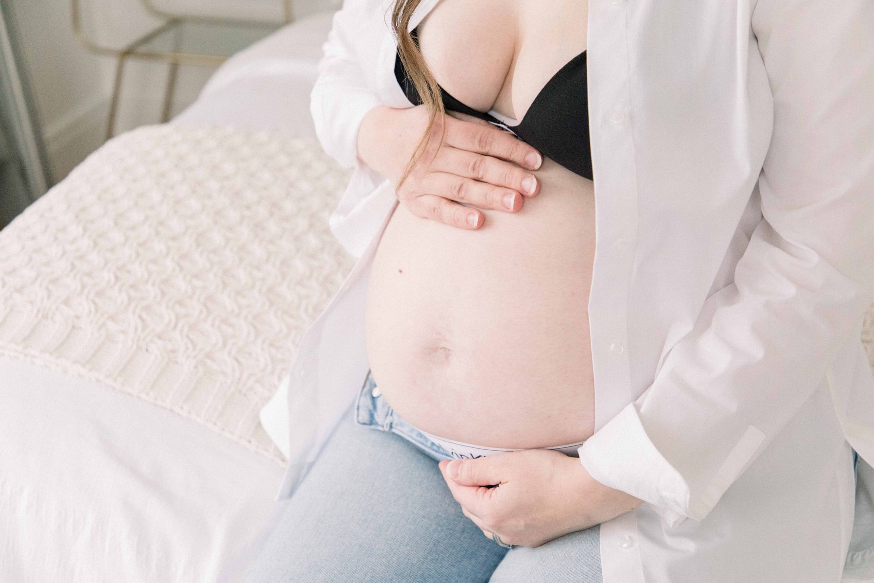 Close up portrait of a pregnant belly with mom holding it. Portrait photography, family photography, motherhood photography, Niagara photographer, Niagara family photography, Vankleek Hill family photography. Emily VanderBeek Photo
