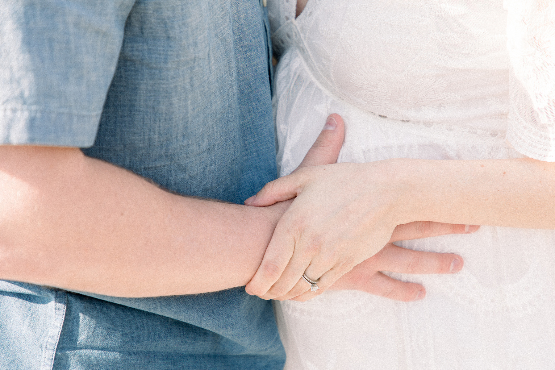 Close up portrait of parents holding pregnant belly, Niagara maternity photography, beach photo session