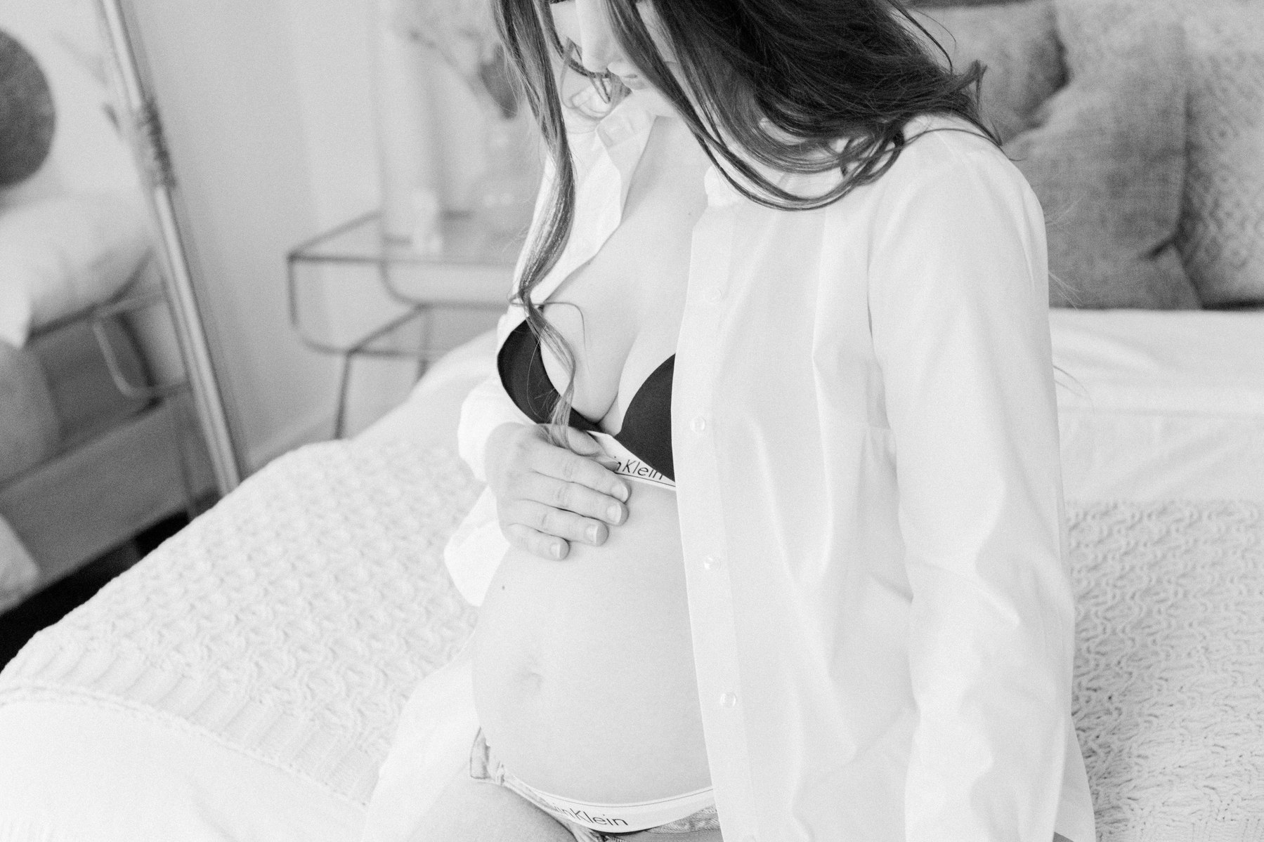 Black & white close up portrait of a mom holding her pregnant belly. Portrait photography, family photography, motherhood photography, Niagara photographer, Niagara family photography, Vankleek Hill family photography. Emily VanderBeek Photo