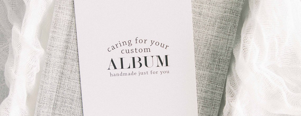 Stylized product photo of grey linen album on textured fabric, Emily VanderBeek Photography, Portrait and Family photography, Niagara Photographer, Champlain Photographer, Vaudreuil-Soulanges Photographer, candid photography, authentic photography.