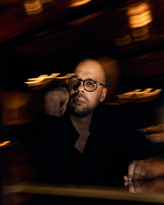 Warm toned portrait with flash and with slow shutter speed of Musa al-Gharbi, American sociologist and assistant professor in the School of Communication and Journalism at Stony Brook University. (Photographed in Chicago, Illinois for The Atlantic)