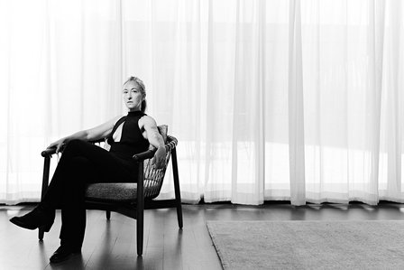 Black and white Environmental portrait of Actress Jessie Fisher at Writer’s Theatre on Aug 13, 2024, in a bright room, seated in a chair. 