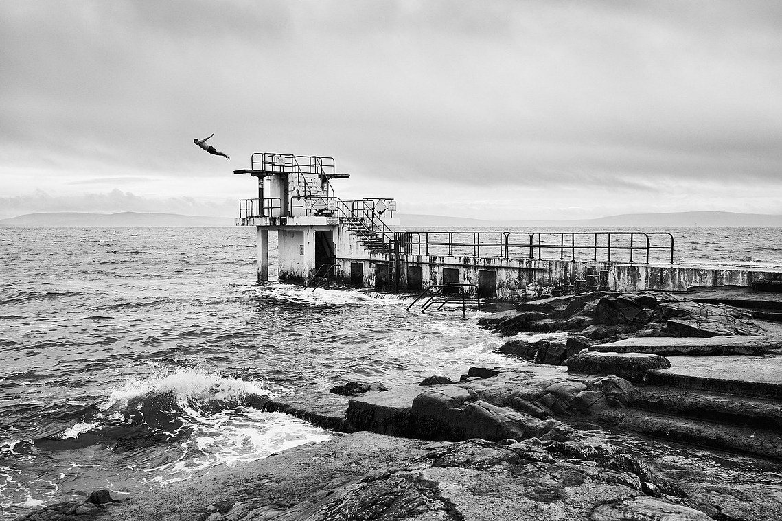 A man dives into Galway Bay at Blackrock diving tower, in Galway. Photo by Janne Hernes.