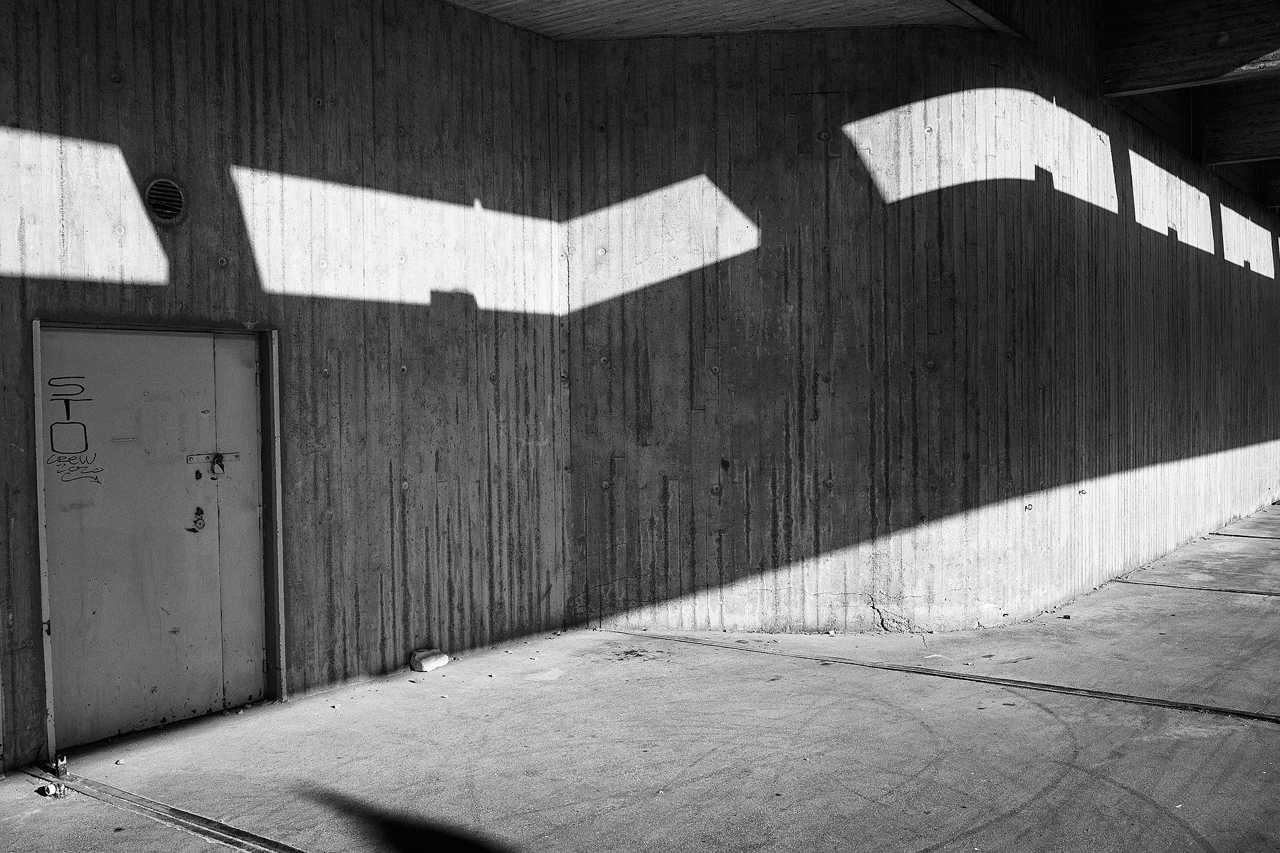 Geometric shadows on a concrete bunker wall in Jätkänsaari, Helsinki