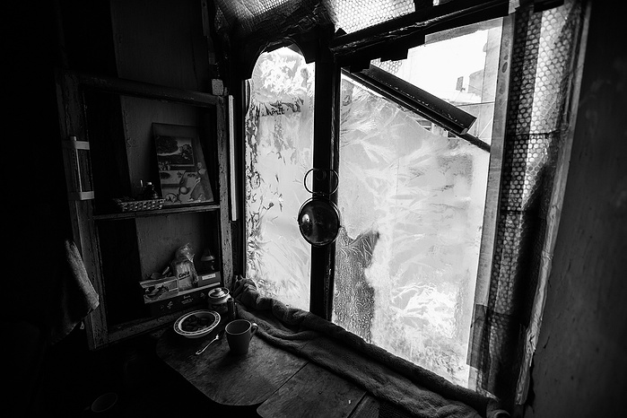 Ice forms on the window of an abandoned building in Moscow.