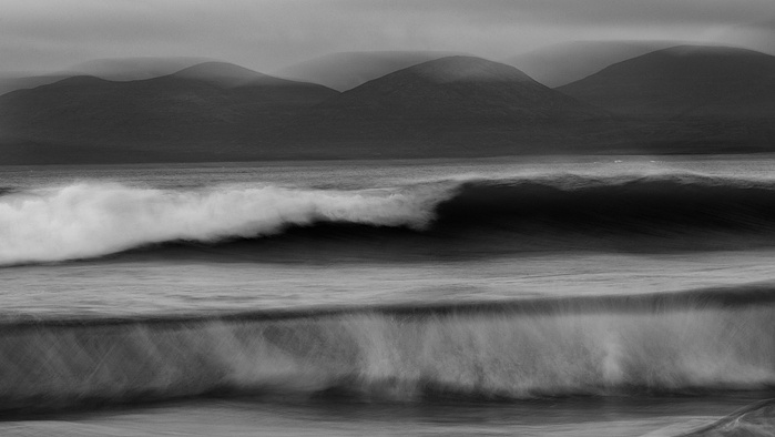 Rolling waves shown in a black and white image on Luskentyre Beach, Isle of Harris, Outer Hebrides, Scotland