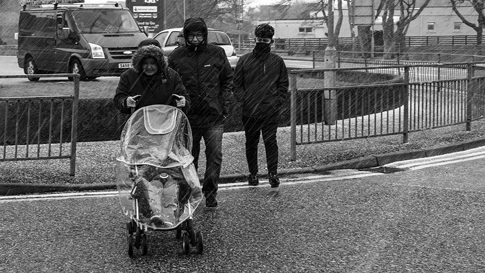 Frishta and her family, all Afghan refugees get caught in a hailstone downpour, Isle of Lewis, Outer Hebrides, Scotland.