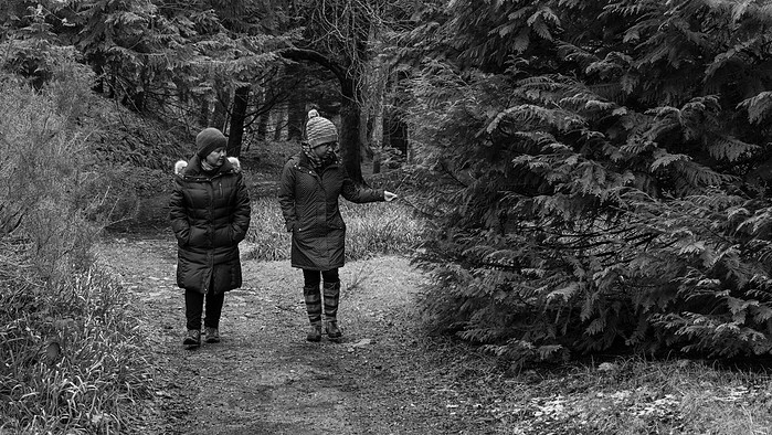 Frishta and her sister Farzana, both Afghan refugees walking through a wood, Isle of Lewis, Outer Hebrides, Scotland.
