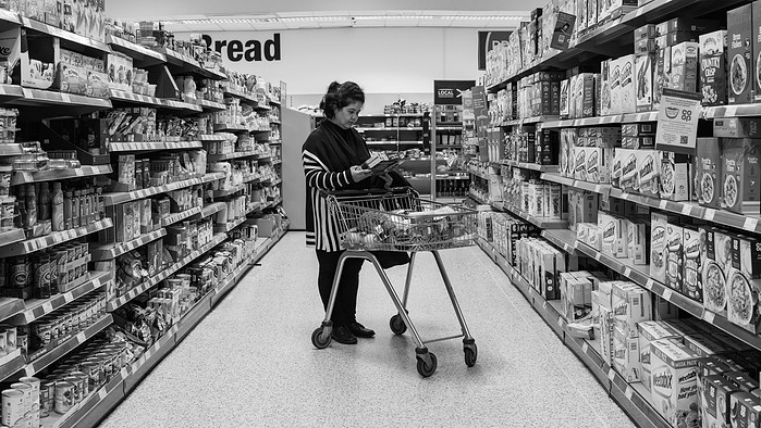 Frishta, an Afghan refugee looking at British foodstuff in a supermarket on the Isle of Lewis, Outer Hebrides, Scotland.