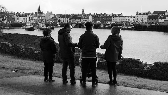 Frishta and her family, all Afghan refugees take in the view over the harbour of Stornoway, Isle of Lewis, Outer Hebrides, Scotland.