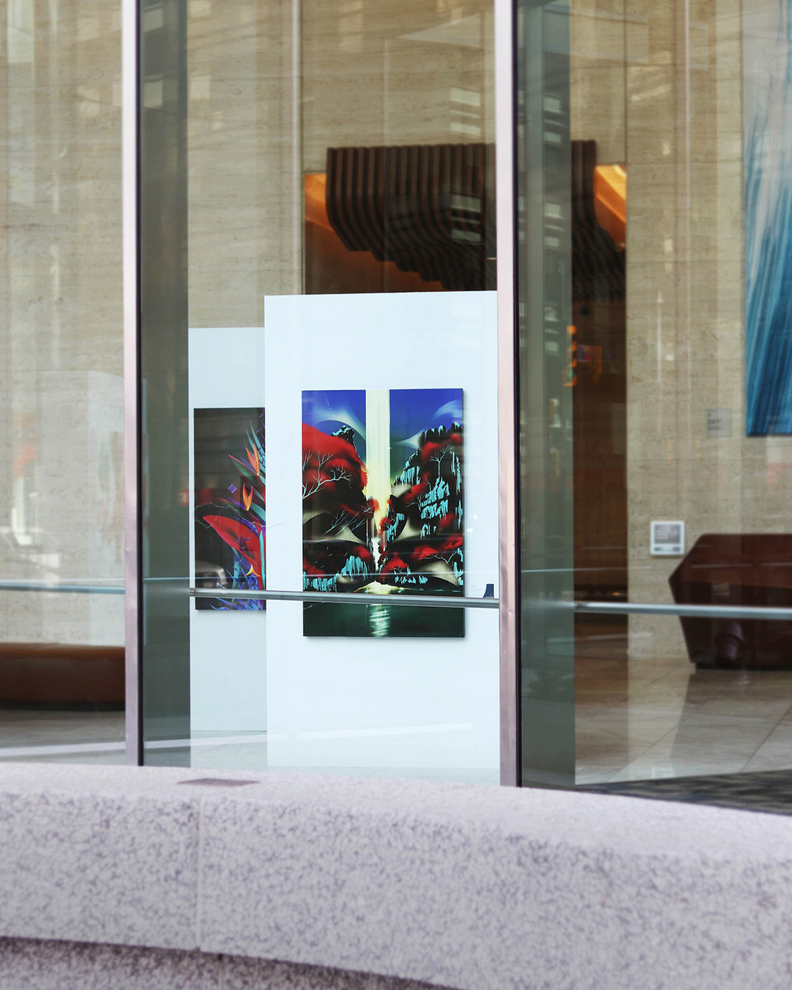 Two vibrant artworks displayed in a corporate lobby in Toronto.