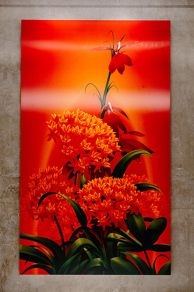 A vibrant red artwork featuring butterfly milkweed and cardinal flowers is displayed on a wall.