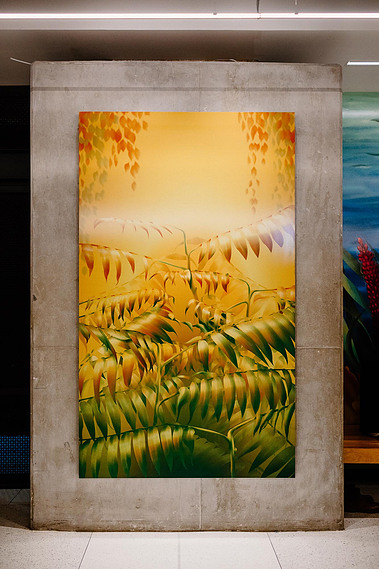 A vibrant yellow and green artwork depicts a bush of staghorn sumac displayed on a wall.