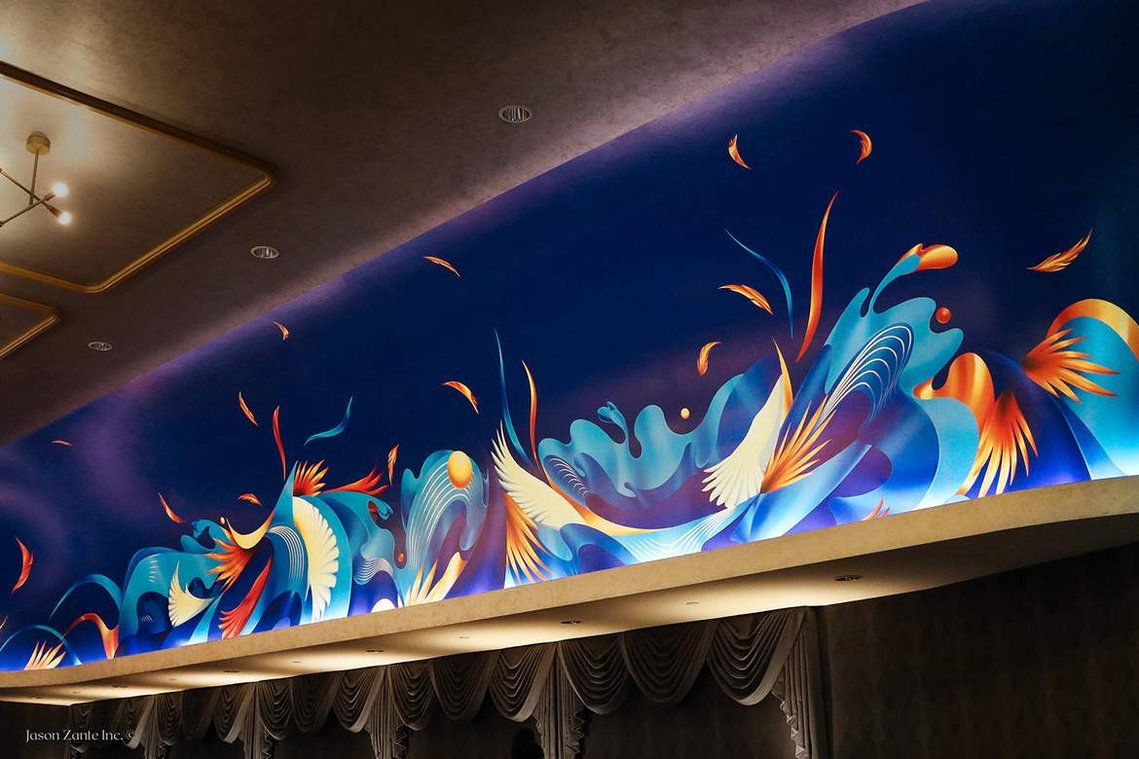 A blue and monochromatic mural in the ceiling wall of a restaurant lounge, depicting the flow of water in a surreal manner.