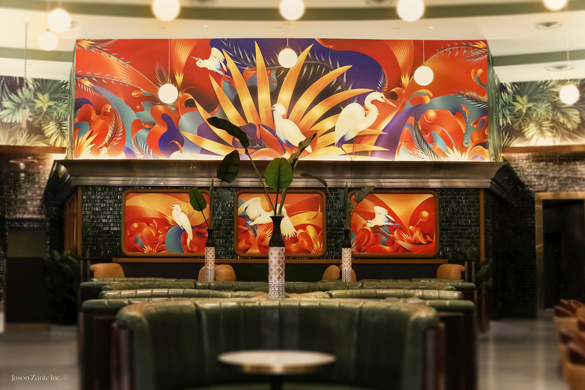 A bold tropical inspired mural depicting white egrets in a lush and green restaurant. 