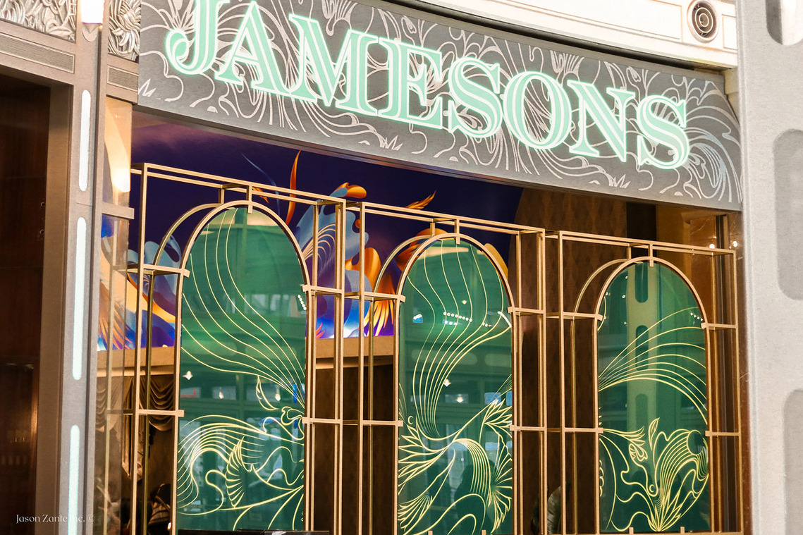 Emerald green glass inspired by art deco outside the façade of a restaurant.