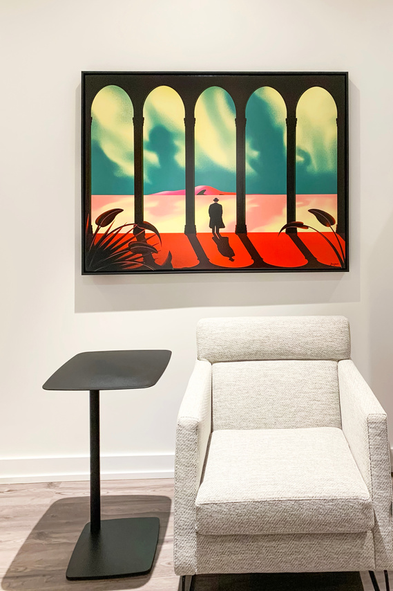 A framed canvas artwork is displayed on a wall inside a modern condominium. 