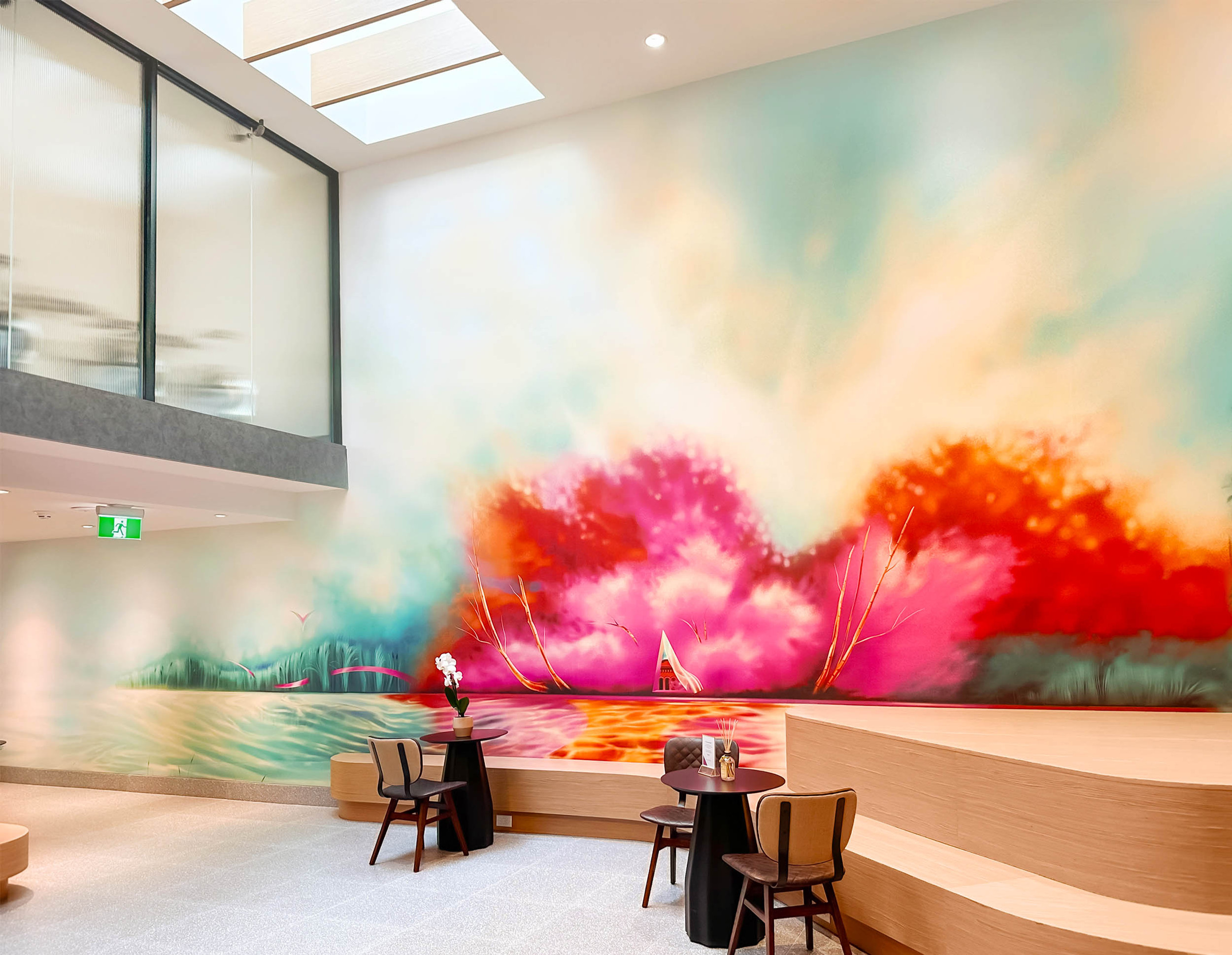 A colorful and scenic artwork mural displayed in a lobby.