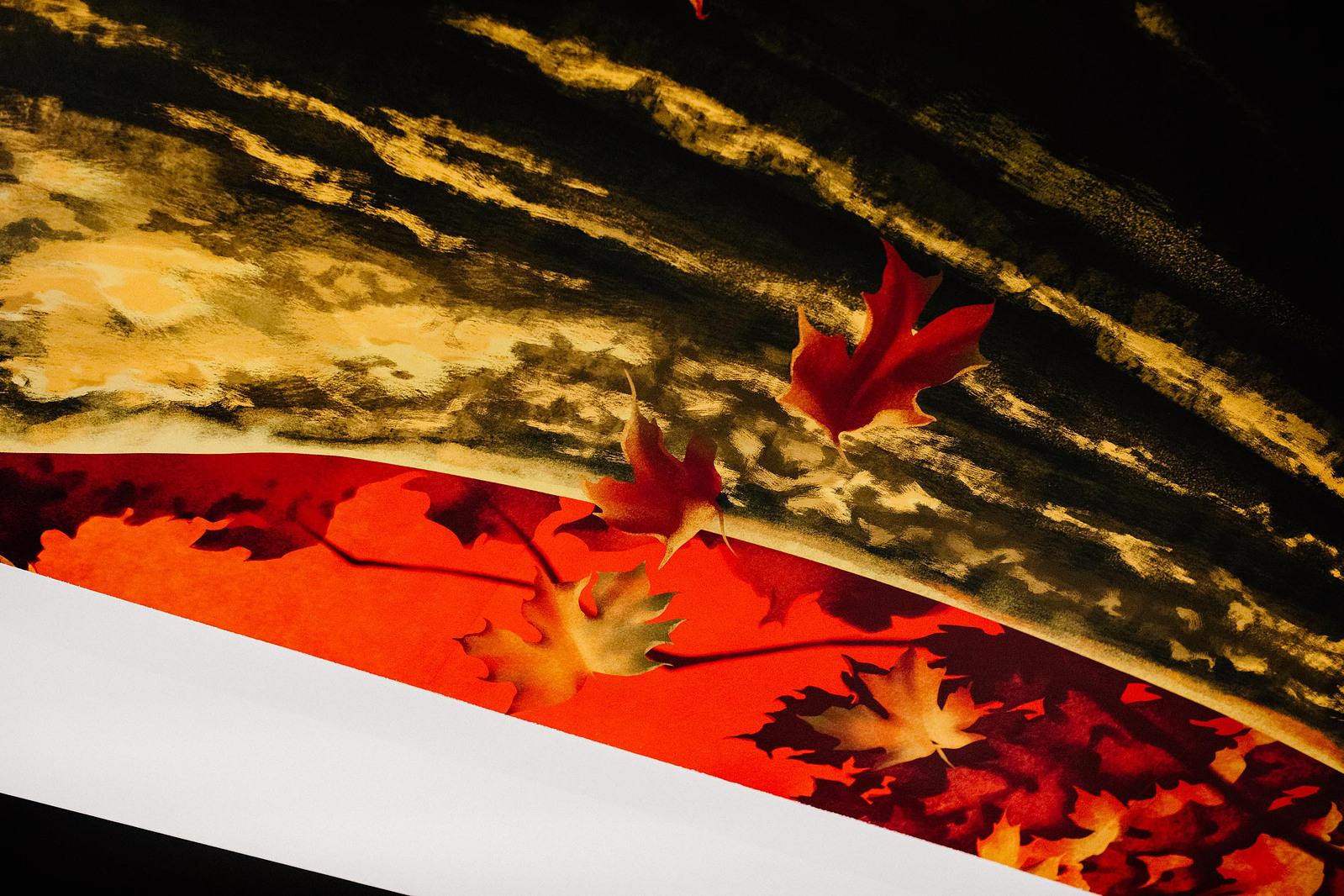 A detailed view of an artwork depicting maple leaves.