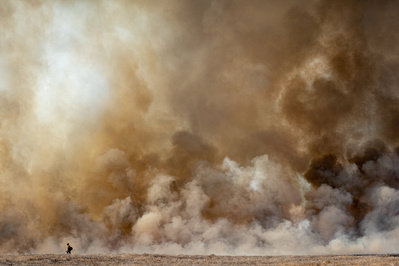 Prescribed Burn Firefighter in front of large smoke