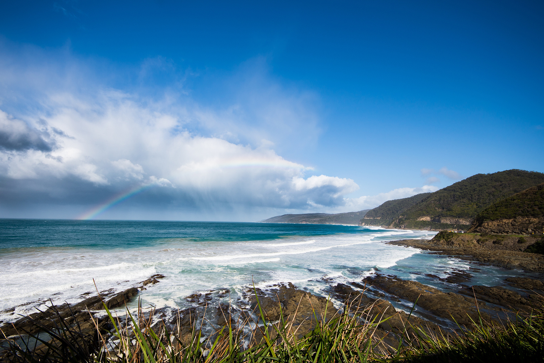 Photo of a rainbow over the ocean taken along the Great Ocean Rd in Victoria by planetdesigns.net