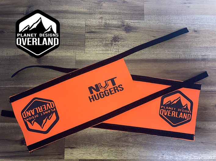 Nut Huggers designed for caravan awning arm locking knob are designed by Planet Designs Overland made in Australia. 2 Orange Nut Huggers are pictured.