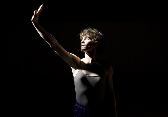 Quinn Hallenbeck dances Serenade in C at Velocity Dance Center in Seattle, her hand blocks the light.