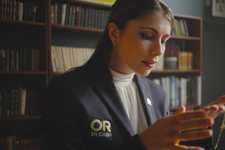 Close-up of a gold expert examining a necklace with precision