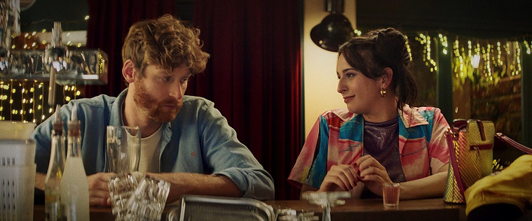 Édouard Deloignon and Audrey Rousseau at the bar, Bloqué.e.s (2024), dir. Chloé Luizard — cinematography Victor Zyński