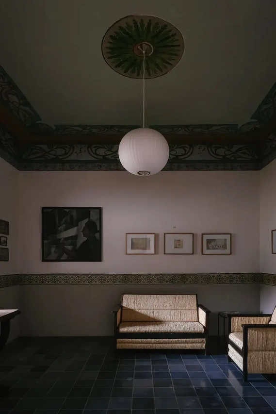A George Nelson pendant lamp hangs from a restored painted-canvas ceiling in the front gallery, which was formerly Urzúa’s studio. Credit Ana Topoleanu