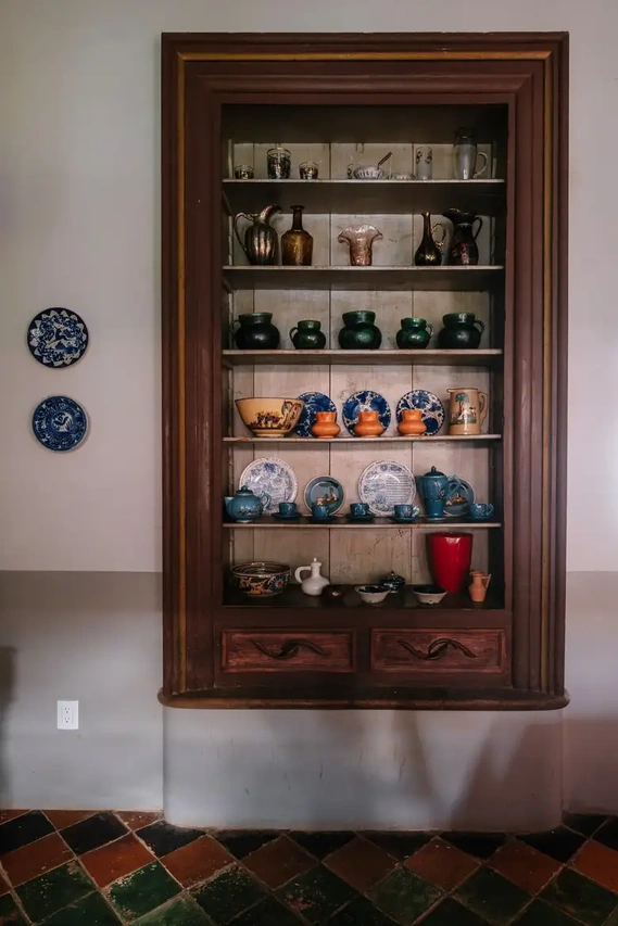 Glass, earthenware and ceramic pieces from the collection of María del Rosario Zambrano, Urzúa’s wife, line a set of shelves in the dining room.Credit Ana Topoleanu