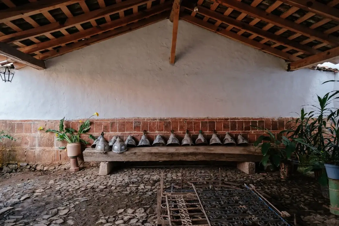 The home’s former corral, now used as a plant nursery, with an original cast-iron lantern designed by Urzúa hanging to the far left. The street lamps and wrought-iron balustrades, recovered by Urzúa from a demolition site in Guadalajara.