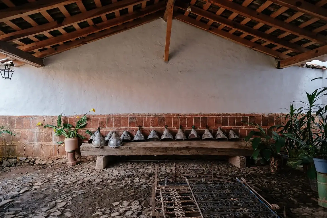 The home’s former corral, now used as a plant nursery, with an original cast-iron lantern designed by Urzúa hanging to the far left. The street lamps and wrought-iron balustrades, recovered by Urzúa from a demolition site in Guadalajara.