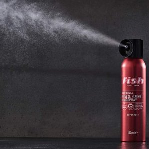 Fish soho freeze fixing hairspray with product spraying out of can. Photographed and styled by cosmetic photographer Tom Hargreaves in his studio in Exeter, Devon