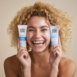 Model holding Coconut milk and cotton, daily moisturiser and sleeping cream. Photographed and styled by cosmetic photographer Tom Hargreaves in his studio in Exeter, Devon