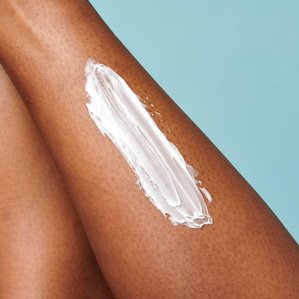 Closeup of moisturiser on models leg. Photographed and styled by cosmetic photographer Tom Hargreaves in his studio in Exeter, Devon