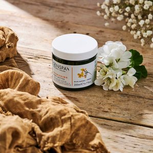 Senspa Nourishing body butter on textured wood with fabrics and flowers. Photographed and styled by cosmetic photographer Tom Hargreaves in his studio in Exeter, Devon