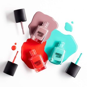 3 Dirty works nail varnishes open and lying in the nail varnish.
Photographed and styled by cosmetic photographer Tom Hargreaves in his studio in Exeter, Devon