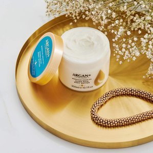 Argan+ ultra rich body butter on gold tray. Photographed and styled by cosmetic photographer Tom Hargreaves in his studio in Exeter, Devon