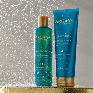 Argan+ strengthen shampoo &amp;amp; conditioner on shower setting with water dripping onto products. Photographed and styled by cosmetic photographer Tom Hargreaves in his studio in Exeter, Devon
