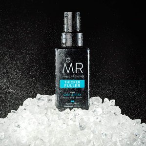 Mr Jamie Stevens thicker fuller salt spray standing in ice and spray in the background. Photographed and styled by cosmetic photographer Tom Hargreaves in his studio in Exeter, Devon