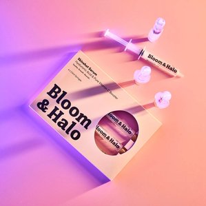 Bloom &amp;amp;amp; Halo skinshot serum box with skin serums around it and neon glow shadow.
Photographed and styled by cosmetic photographer Tom Hargreaves in his studio in Exeter, Devon