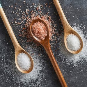 3 different Dr Salts salts in wooden spoons on a slate tile background. Photographed and styled by cosmetic photographer Tom Hargreaves in his studio in Exeter, Devon